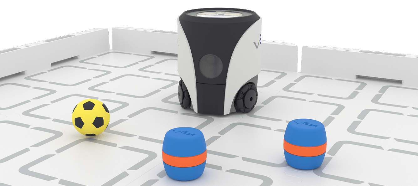 VEX AIM Coding Robot is on a field with 2 blue barrel and 1 sport ball in front of it.