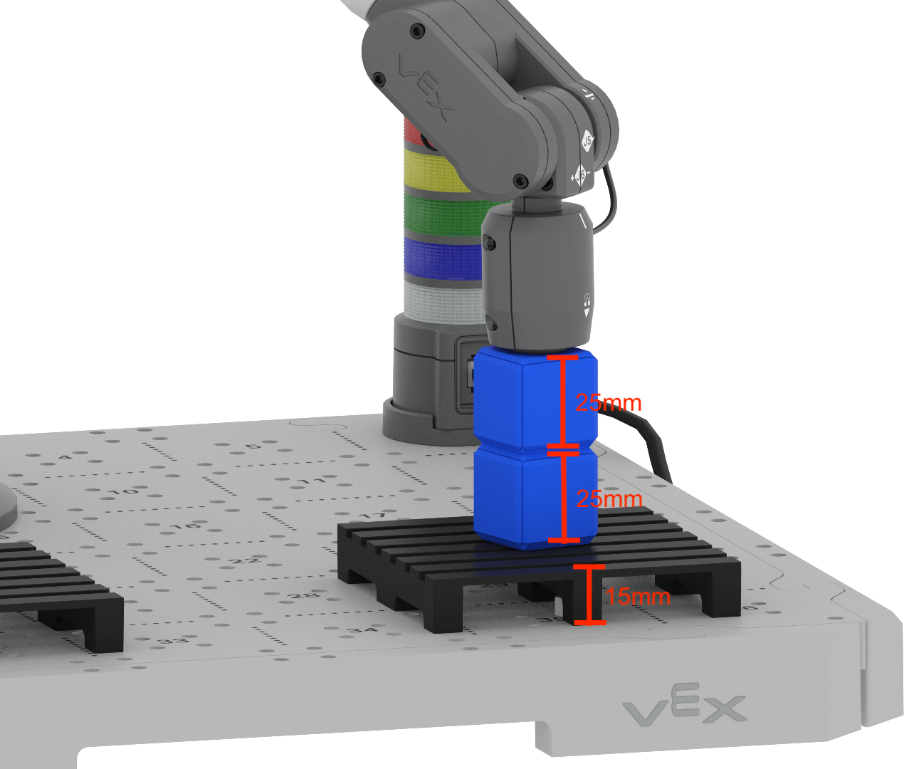 An angled view of the CTE Tile, showing a pallet with two blue Cubes stacked on a pallet with the 6-Axis Arm's Magnet Pickup tool placing one cube down onto the other one. There are red lines measuring the height of objects. The pallet is measured as 15 mm tall. Each blue cube is measured as 25 mm tall.