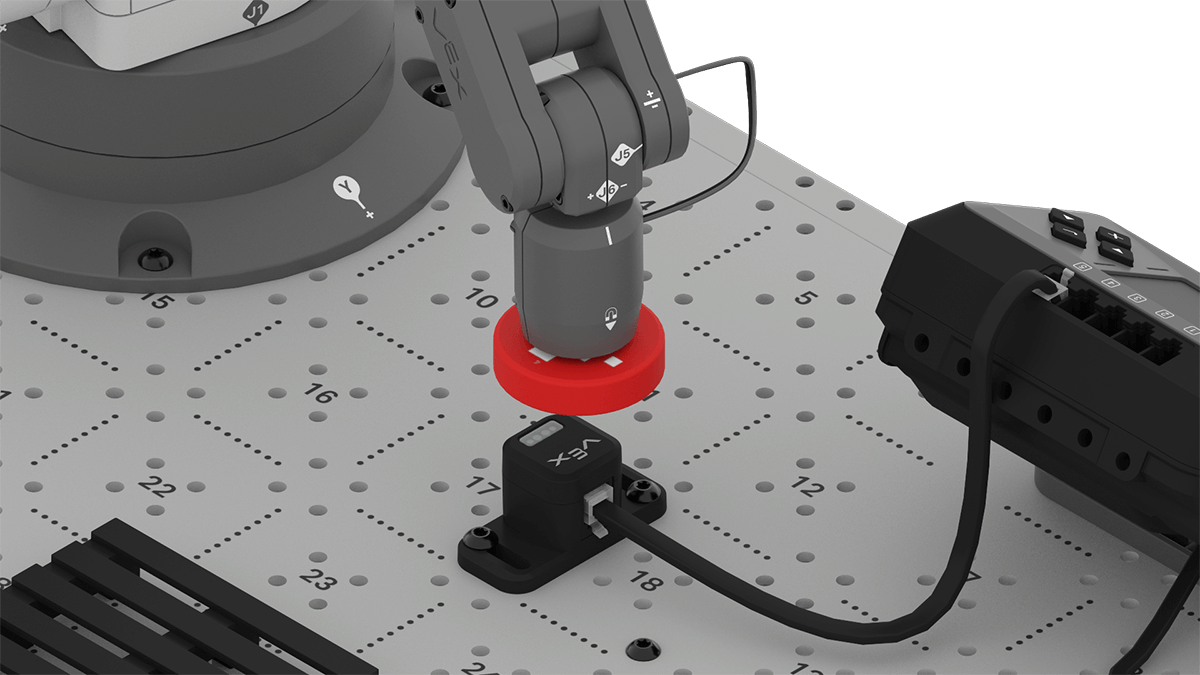 Close up view of the 6-Axis Arm holding a red disk above the optical sensor.