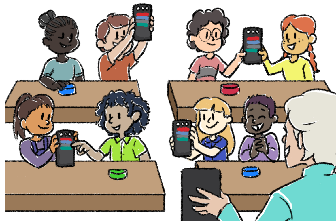 Students in a classroom facing the teacher and holding up their Coders to show their projects.