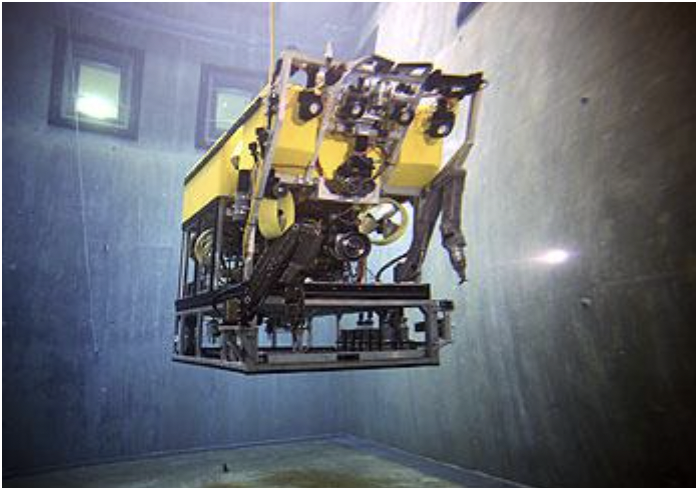 Underwater remotely operated vehicle in a tank ready to perform tasks.