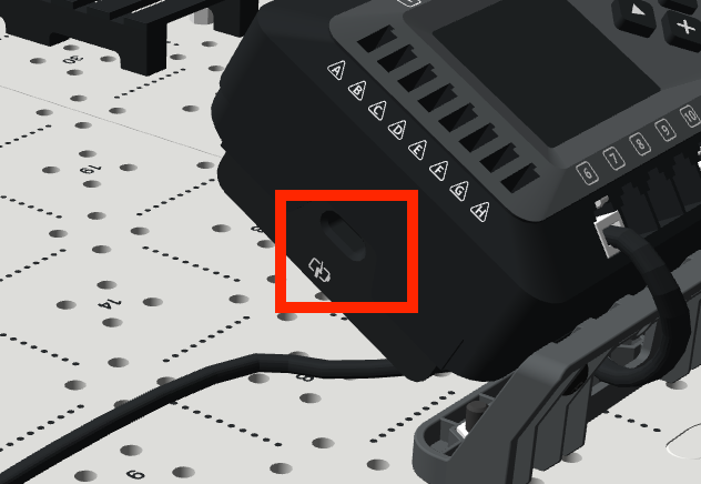 Close up image of the EXP Brain on the Tile with a red box around the charging port on the side of the Brain, indicating where to connect the power source to the Brain.