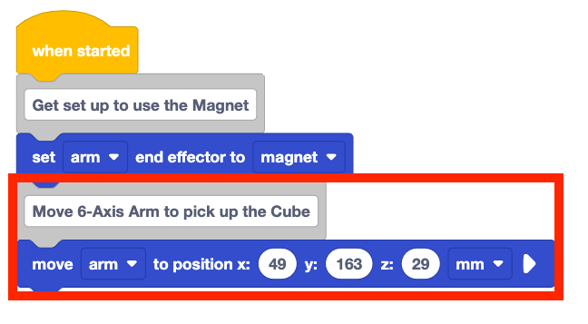 The same stack of blocks from before, but now there is two new blocks added on to the bottom of the stack. These new blocks are a comment block that reads move 6-axis arm to pick up the cube and a move arm to position x 49 y 163 z 29 mm block. These two new blocks are highlighted with a red box.