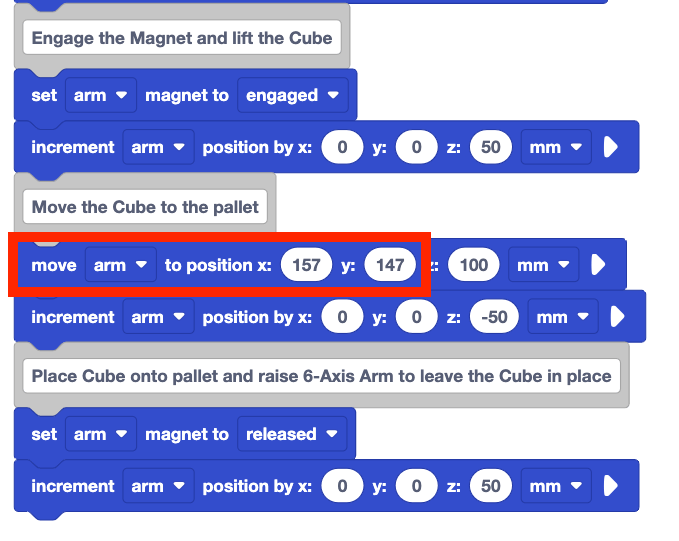 The same stack of blocks from before, but now, the move arm to position block directly beneath the Move the Cube to the pallet comment block is modified. The block now reads move arm to position x 157 y 147 z 100 mm. These modified x and y values are highlighted with a red box.