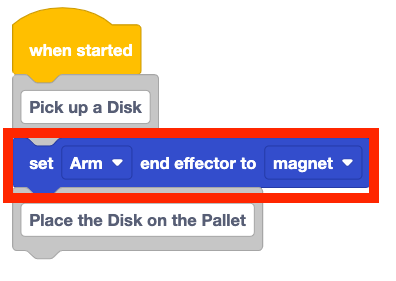 The same project, with a set end effector block added beneath the first comment. The start of the project now reads When started, Pick up a disk, set arm end effector to magnet. 