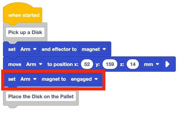 The same project with a set magnet block added after the move to position block. The first comment section of the project now reads Pick up a disk; set arm end effector to magnet; move arm to position x 52, y 159, z 14 mm; set arm magnet to engaged.