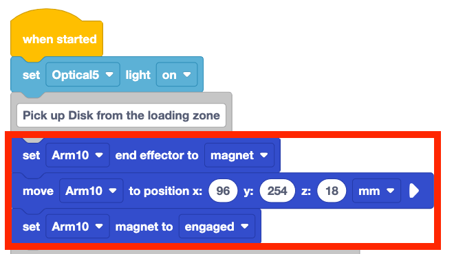 VEXcode project with a When started block and 5 blocks below. The first two blocks are the set optical light and the first comment. Three blocks have been added between the first and second comments. These blocks read set arm 10 end effector to magnet, move arm 10 position to x 96 y 254 z 18, and set arm 10 magnet to engaged.
