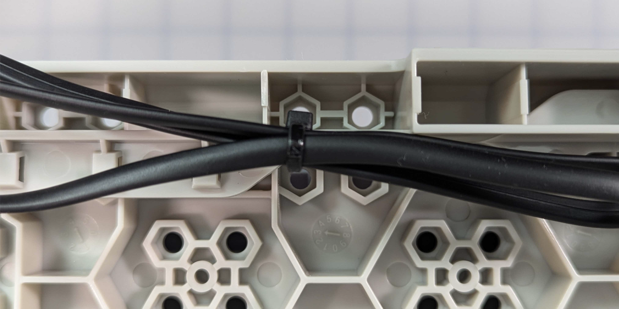 Cable on the bottom of the CTE Workcell, secured by a zip tie to reduce slack.
