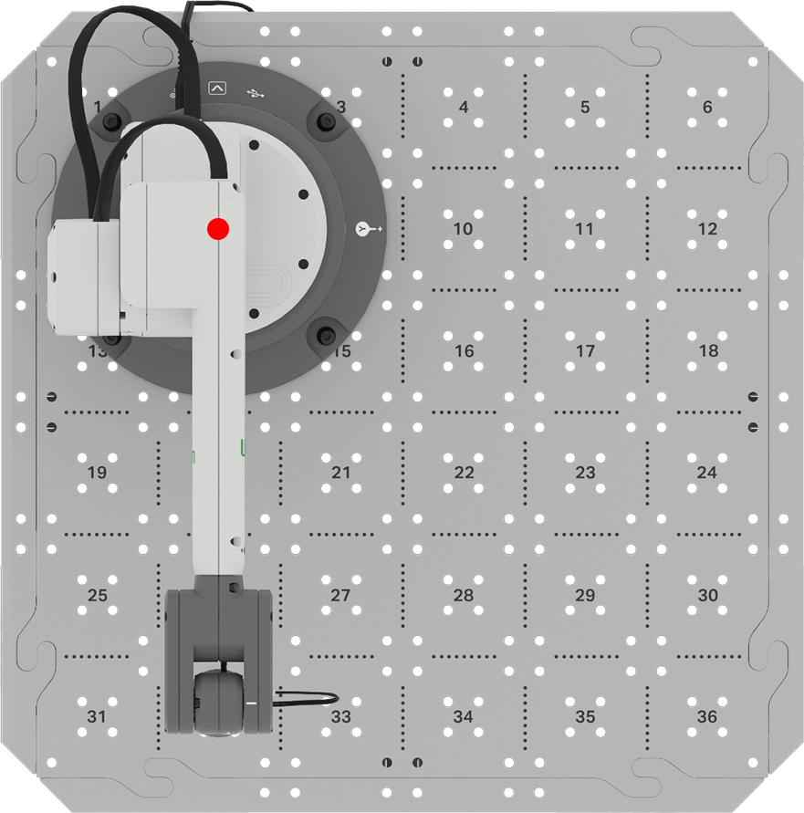Top down view of the CTE Workcell setup with platform and 6-Axis Arm. A red dot calls out the origin of the arm located at the center of its base.