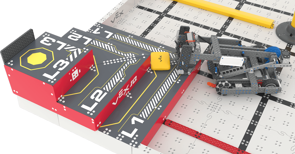 A close-up angled view of Flop, the VEX IQ Robotics Competition 2026-2027 Hero Bot, scoring a yellow Bean Bag on L1 of the red Pyramid Goal.