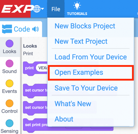 VEXcode EXP Toolbar with the File menu open, and Open Examples selected with a red box. 'Open Examples' is the fourth item in the menu, beneath 'New Blocks Project', 'New Text Project', and 'Load From Your Device'.