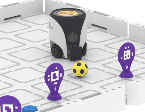 AIM robot in the process of kicking a ball into a goal made by april tags.