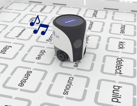 A VEX AIM Coding Robot on a field. Different adjectives and verbs are written on the field for the robot to use in the diamond poem it is making.